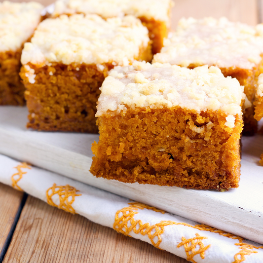 woman with flowers holding a pecan chai spice cake